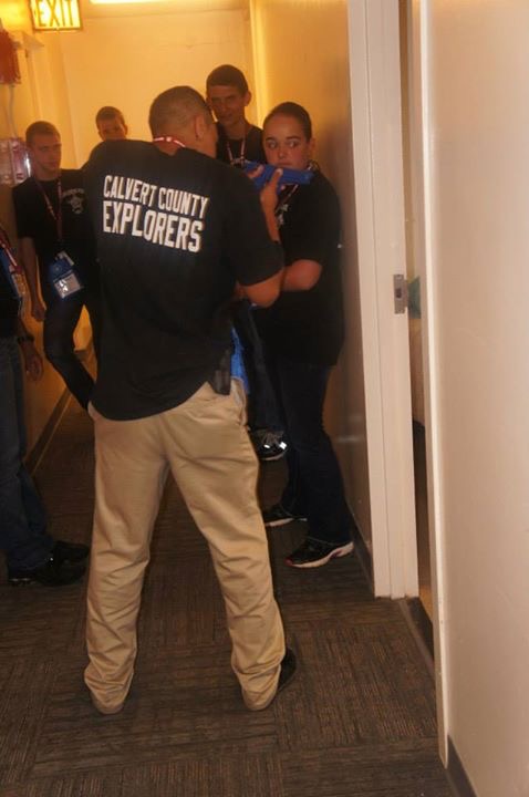 Explorers in doorway simulating police take down