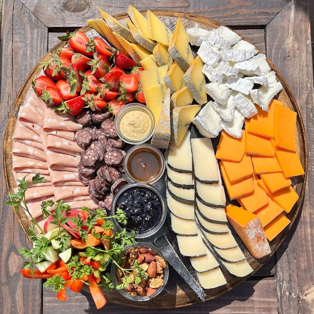 Charcuterie board with meats, cheeses and fruits