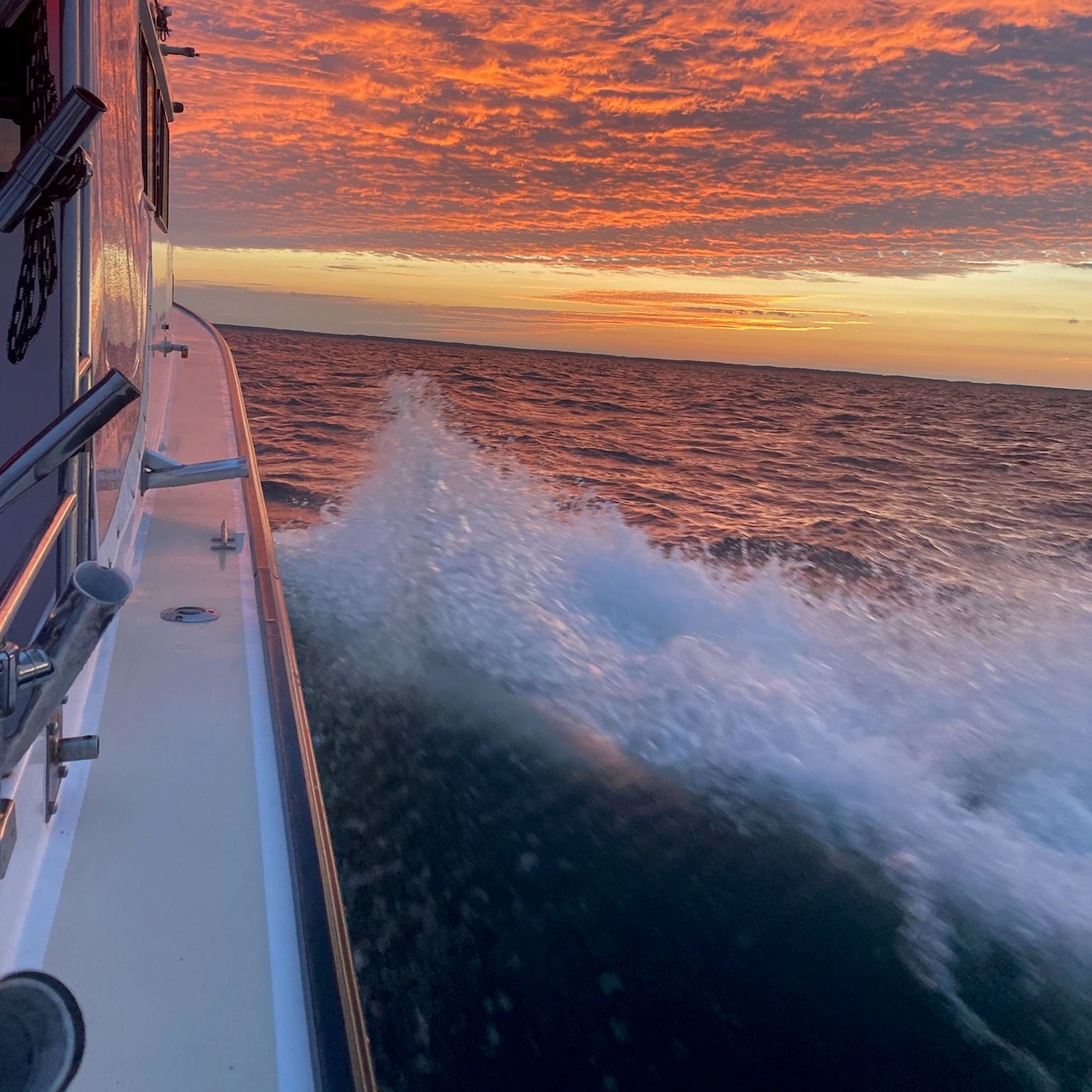 Boat at sunset making waves