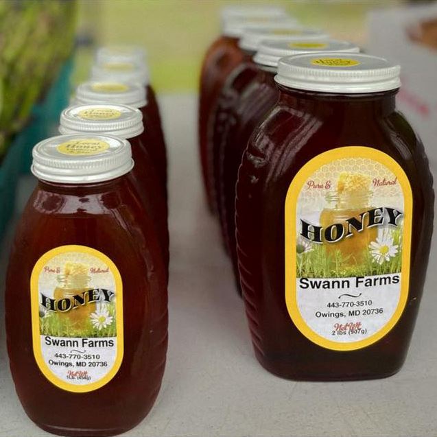 Small and Large jars of honey with Swann Farms labels