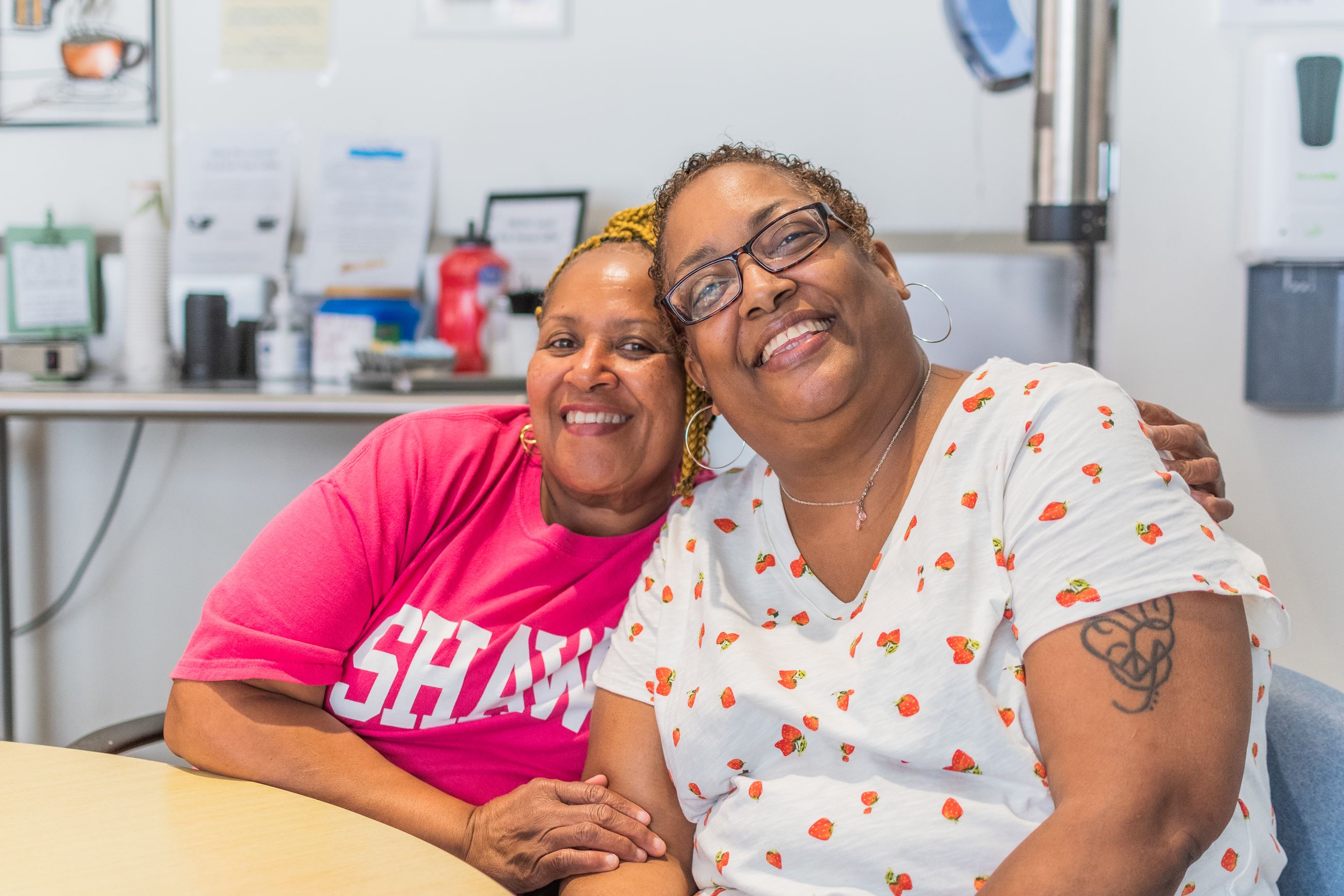 Two women sitting and smiling