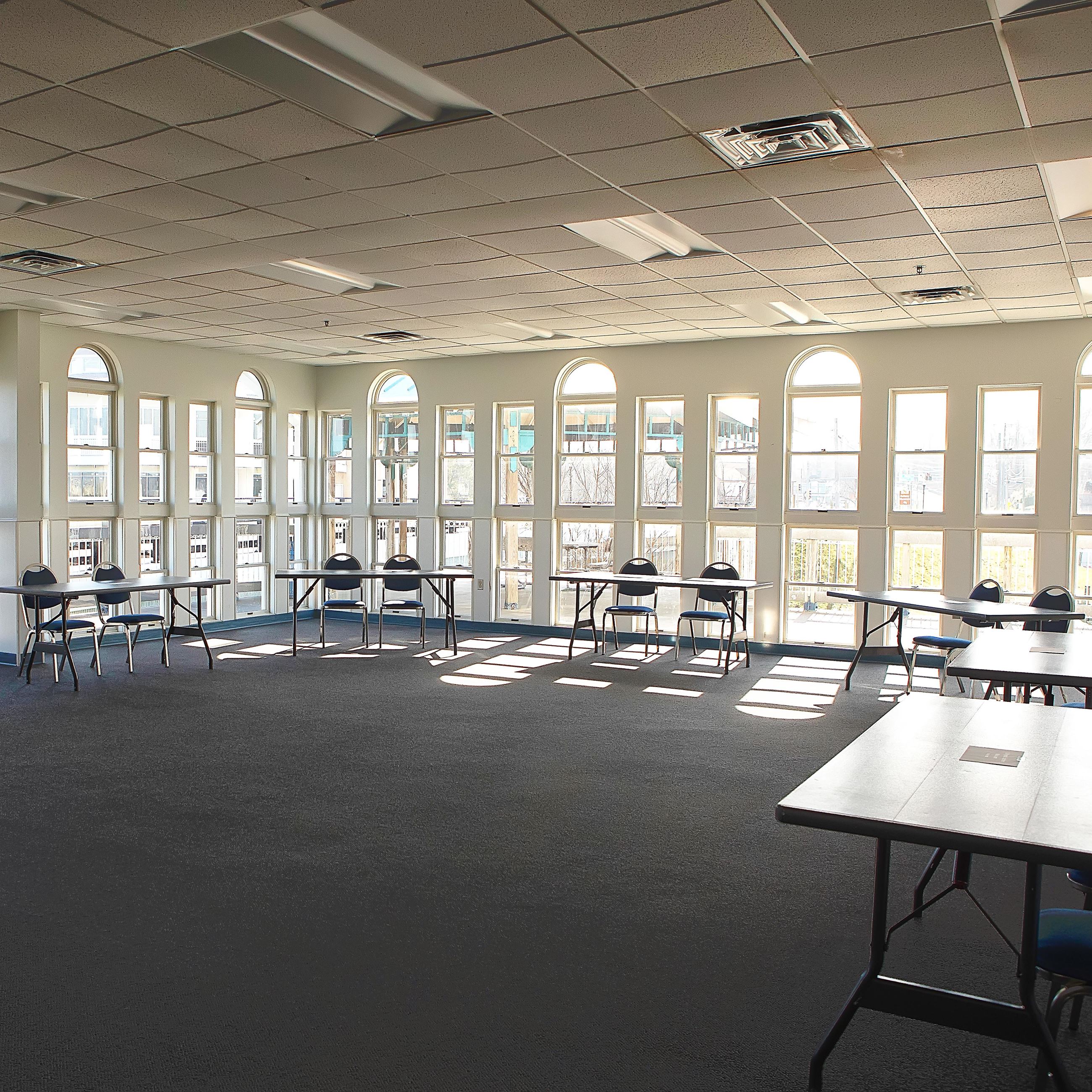 Meeting room with large windows and tables and chairs