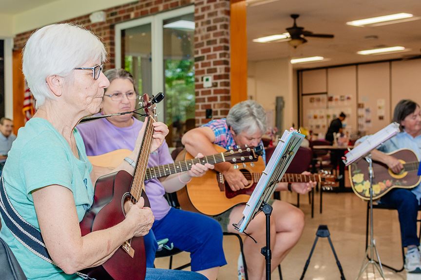 Aging women playing guitar