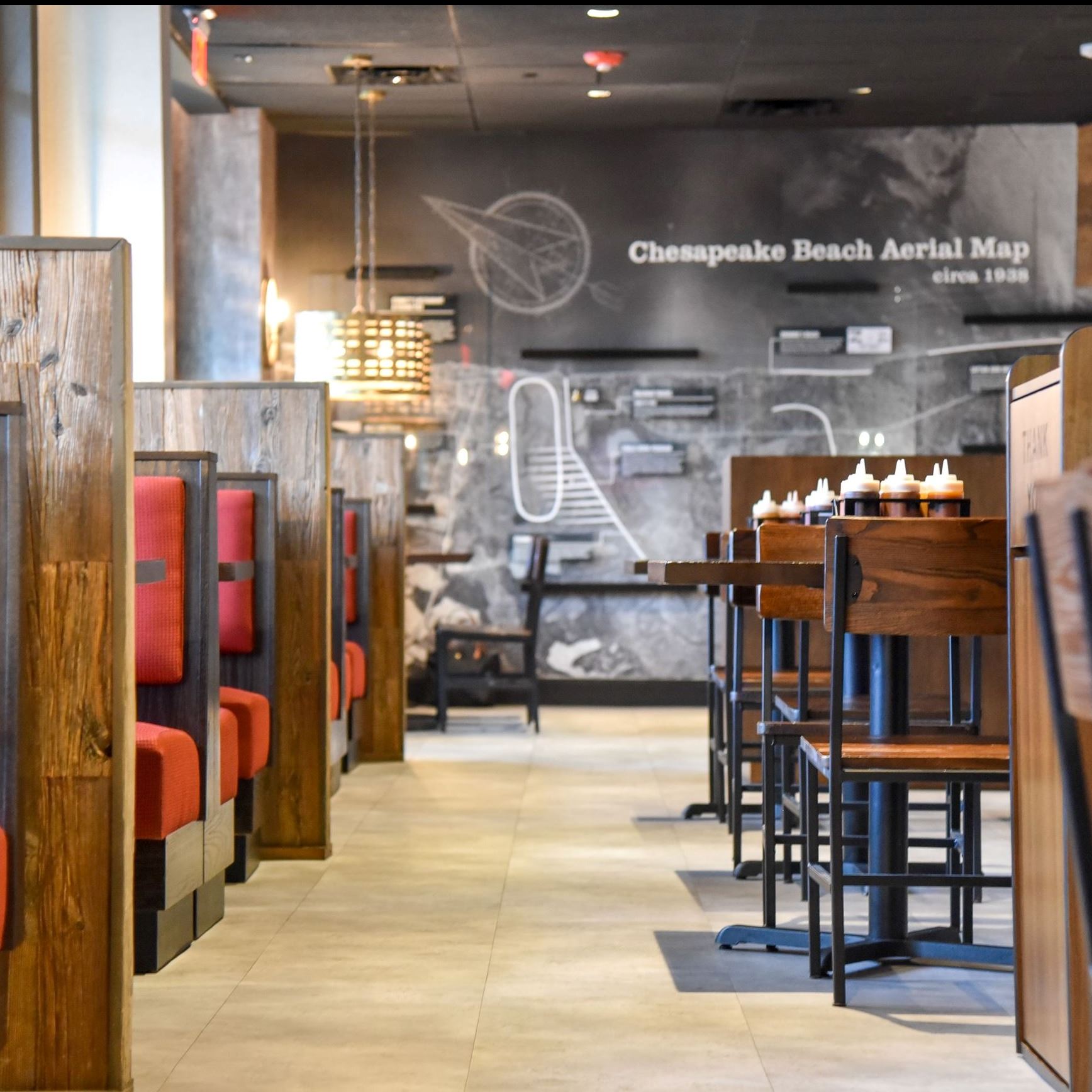 Tables chairs and booths inside a restaurant