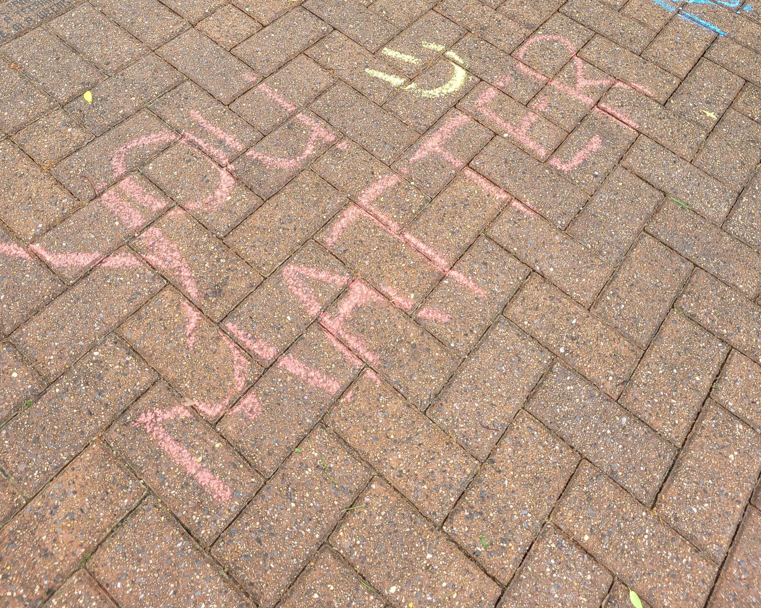 Chalk art of a whale, dinosaur and frogs with text "Together we can. The food here is dino-mite!&